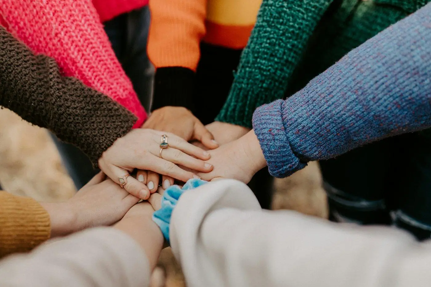 A circle of team members stacking their hands together